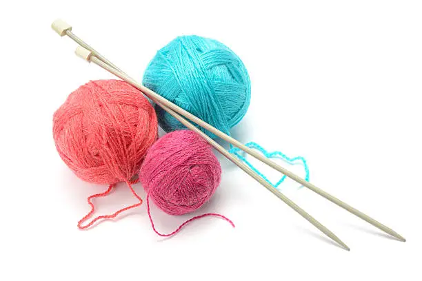 Woolen balls and knitting needles isolated on white
