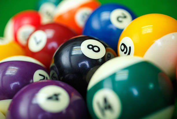 istock billiard balls on a green pool table, closeup 509857514