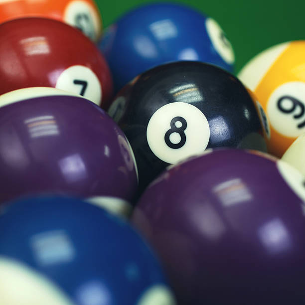 istock billiard balls on a green pool table, closeup 509857728