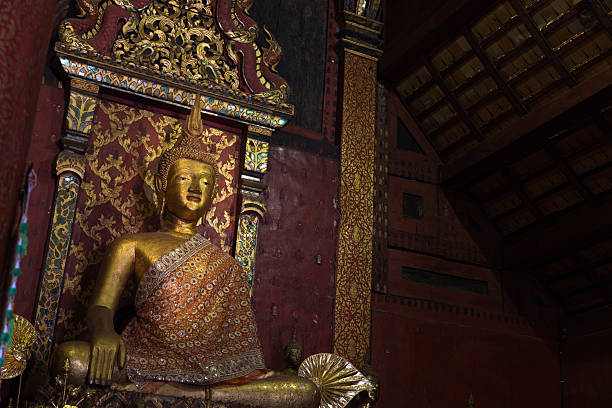 istock meditating golden budddha statue 509857746