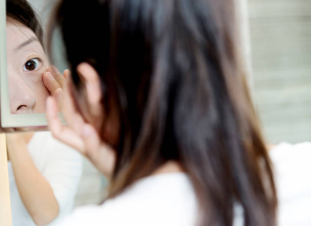 istock Young woman looking herself in the mirror 509857760