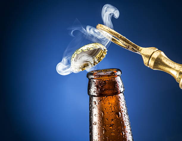 Opening of beer cap with the gas output. Opening of beer cap with the gas output. Blue background. opening bottle cap photos stock pictures, royalty-free photos & images