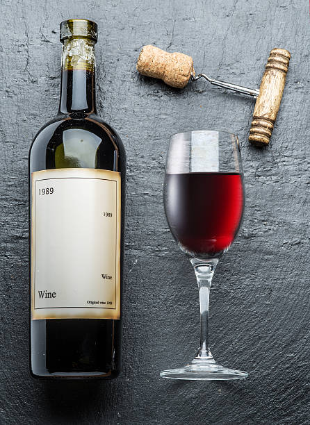 istock Wine bottle, wine glass and corkscrew on the graphite. 509858942