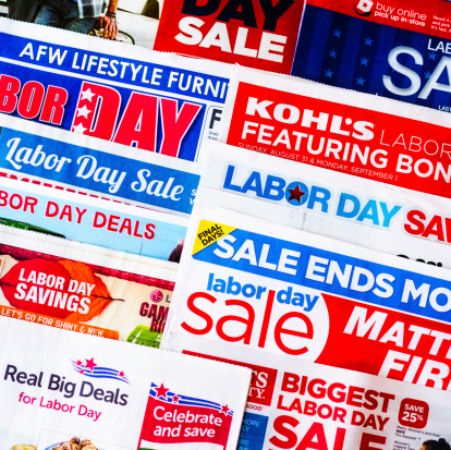 Colorado Springs, Colorado - August 31, 2014: A square format studio shot of a collection of 2014 American newspaper inserts promoting various Labor Day sales.