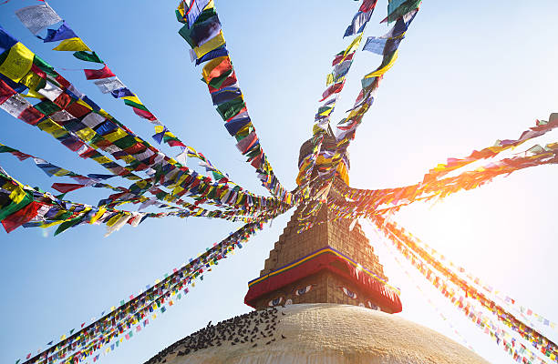 istock Prayer flags flying against the sun from the Boudhanath Stupa 509860475
