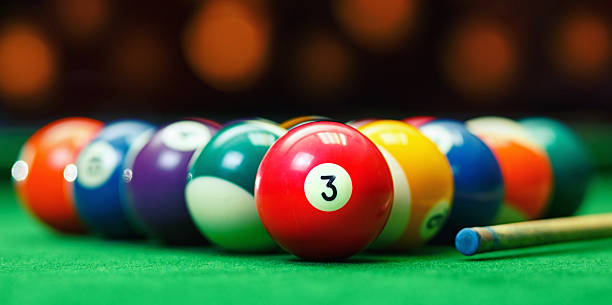 istock Billiard balls in a green pool table 509860844