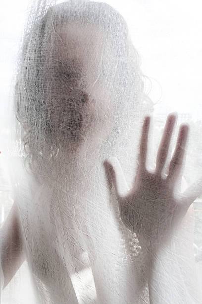 istock Young Woman Behind a White Curtain 509861196