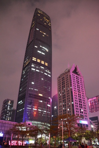 Shenzhen, China - April 15, 2014: local people walking at night under KK100 Super Tall skyscrape. It's the tallest building in Shenzhen (442 mt height) and as well the 14th tallest building in the world.