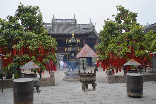 Zhujiajiao, China - May 17, 2014: City God Temple, a Taoist temple, is located in the center of Zhujiajiao old town. In the background, local tourists walking inside the temple courtyard