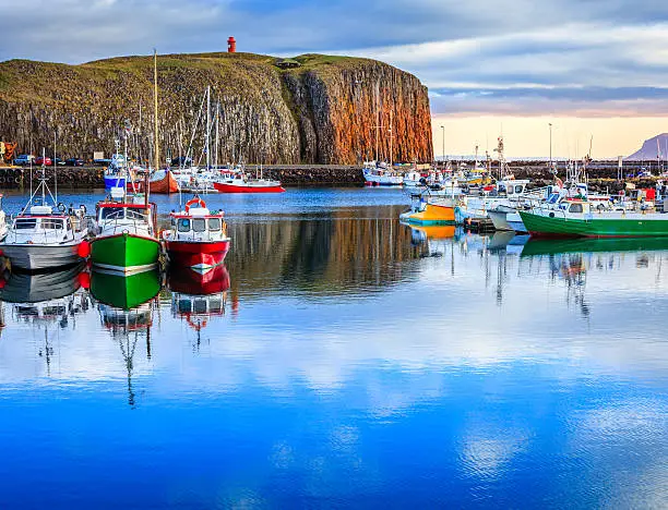 The colorful boats in peaceful Stykkisholmur's harbor in western Iceland