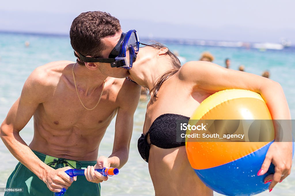diver loves  girl with a ball diver loves a girl with a ball. couple on the beach 20-29 Years Stock Photo