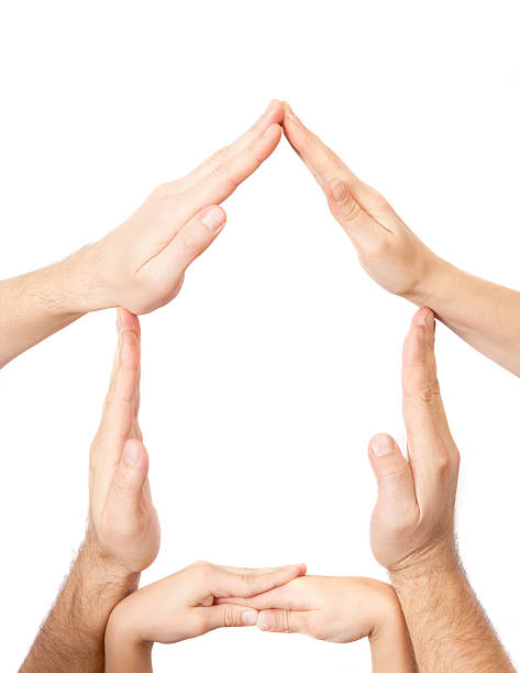 istock Hands of three people made a home shape 509862211