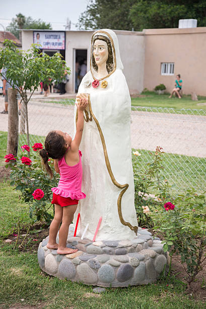 Child touches Mary the Mystical Rose stock photo