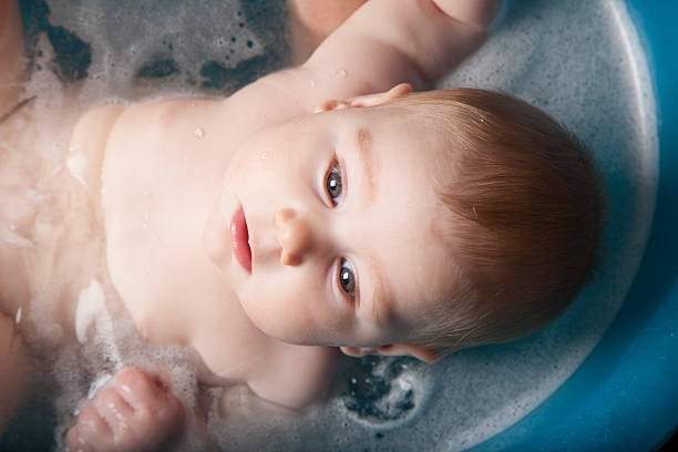 istock baby washing in blue bath 509862822