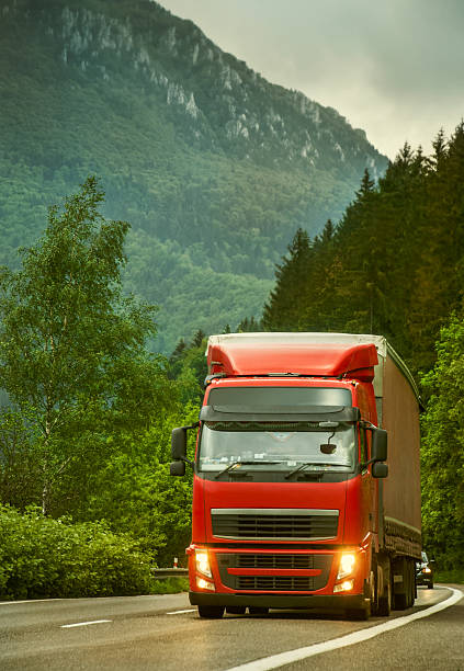 istock Red truck on mountain highway in the evening 509862827
