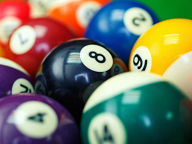 istock billiard balls on a green pool table, closeup 509866552