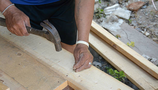 istock carpenter's hands hitting a nail on the head 509866921