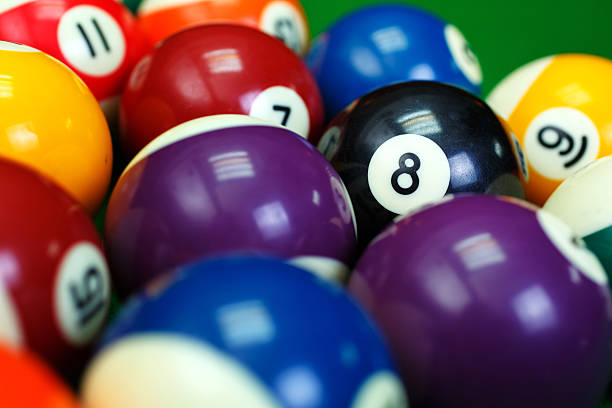istock billiard balls on a green pool table, closeup 509867030
