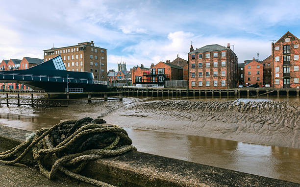 River Hull with house, flats, church in Hull, Yorkshire, UK. Hull, Yorkshire, UK. View across the river Hull in winter with view of Scale Lane swing bridge and house, offices and Holy Trinity Church on the horizon in Hull, Yorkshire, UK. hull house stock pictures, royalty-free photos & images