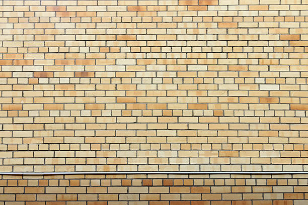 Yellow surface of brick wall background - part of modern building