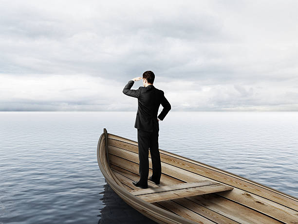 istock businessman standing on a boat 509872874