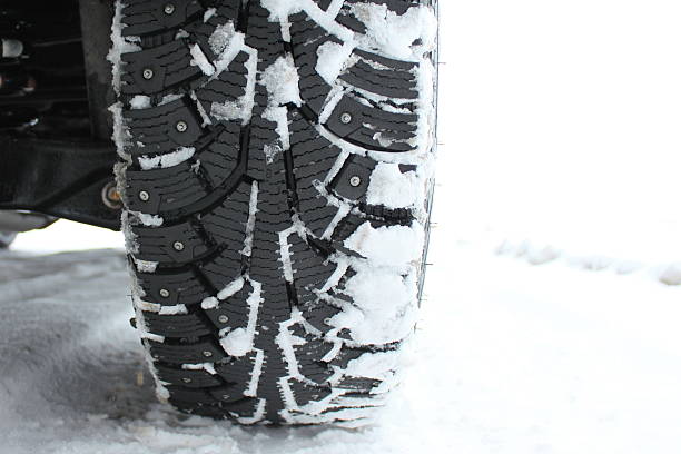 istock Studded snow tire in the winter close-up 509892993
