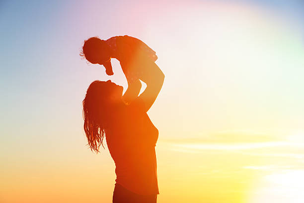 istock happy mother and baby having fun at sunset beach 509893609