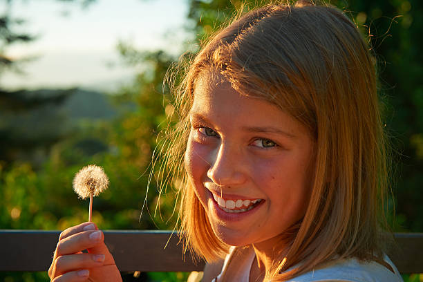 istock Girl Smiling With Dandelion.Color Image 509895703