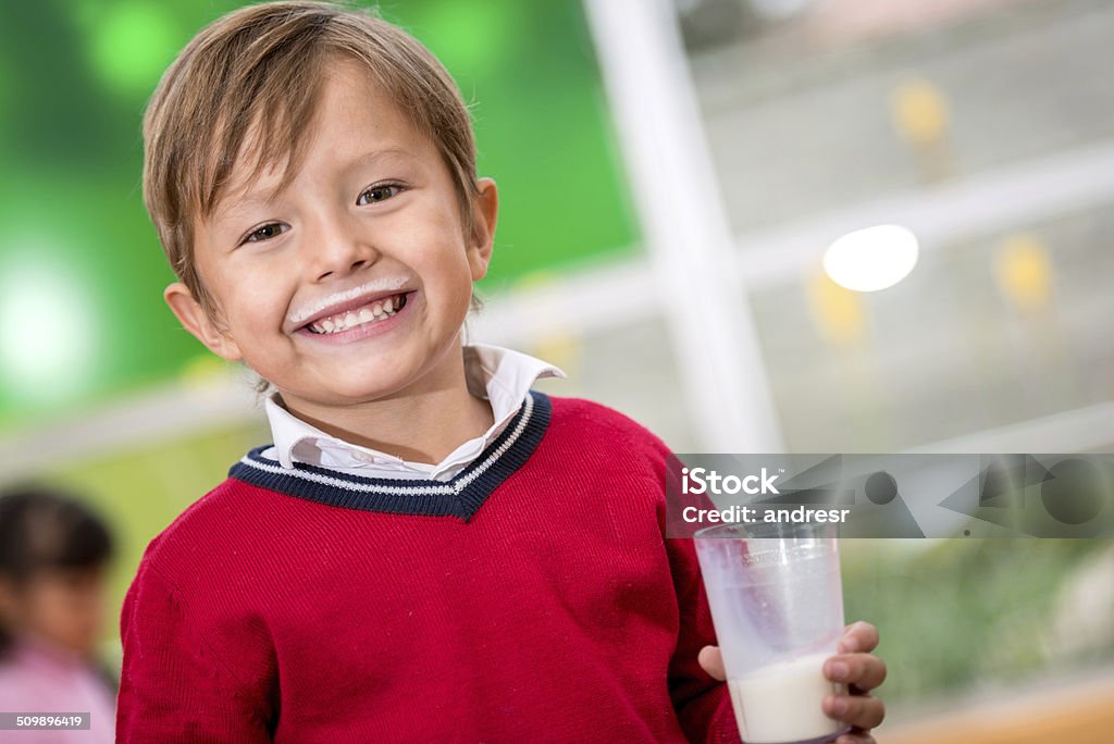 Boy drinking milk Happy boy drinking milk at school Milk Mustache Stock Photo