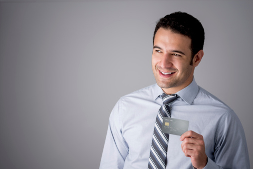 Successful business man holding a credit card