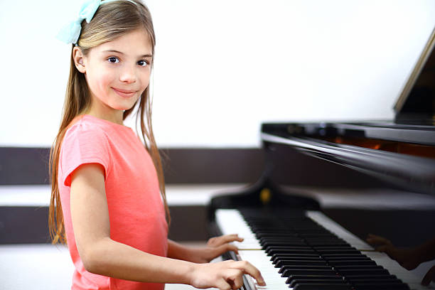 istock Little girl playing piano. 509897977