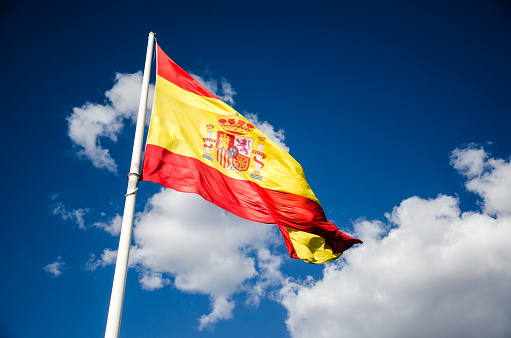 Spanish flag waving in the wind. This photo is taken in Plaza de Colón, Marid.
