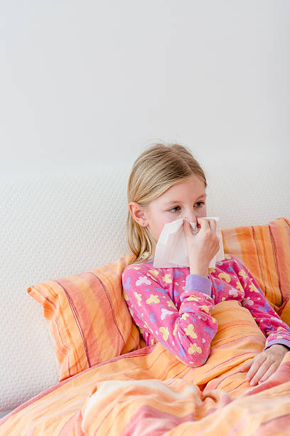 istock Sick little girl cleaning nose 509906388