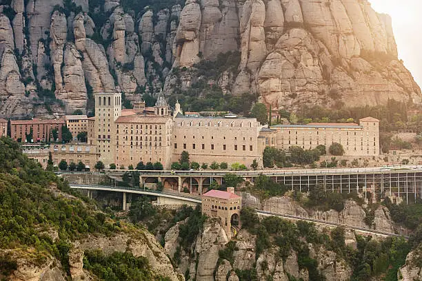 Sunset at Santa Maria de Montserrat Monastery. Famous Benedictine Monastery in between cliffs in the mountains near Barcelona, in Catalonia, Spain