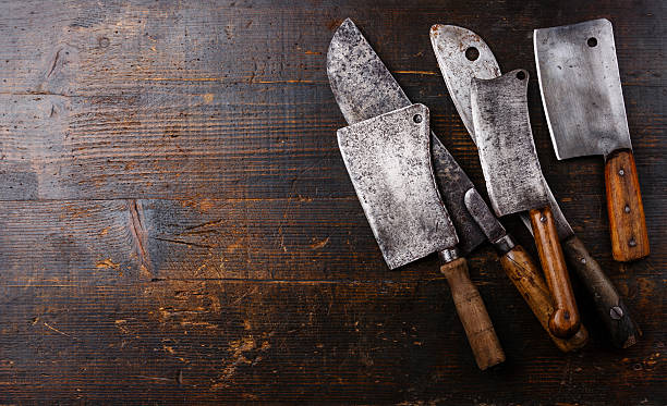 Butcher cleavers on wooden background