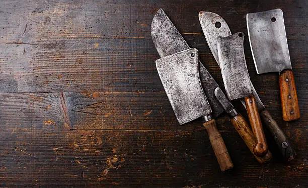Photo of Butcher cleavers on wooden background