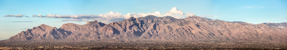 Located in Coronado National Forest just north of Tucson, Arizona, the Santa Catalina Mountains are considered Tucson's most prominent mountain range. Vegetation varies from ponderosa pines on Mount Lemmon (the highest peak at just over 9,000 feet) to unique desert vegetation in lower elevations. At approximately 2,500 feet, the foothills appear miniaturized in comparison to the majestic mountains. Panoramic, HDR image.