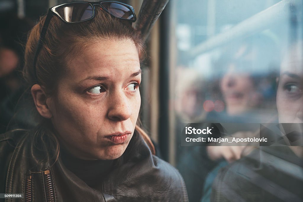 City life solitude Young woman feeling alone in the public transport Bus Stock Photo