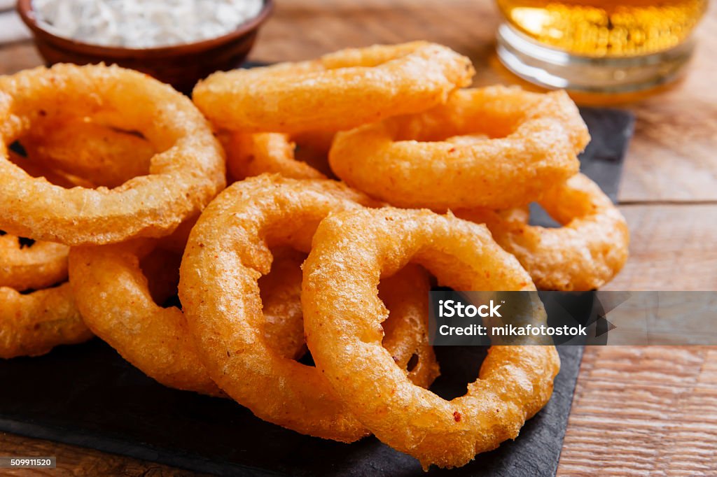 fried onion rings in batter with sauce Appetizer Stock Photo