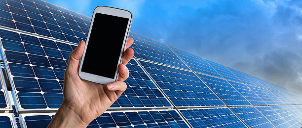 istock Hand with smart phone and solar panels 509912696