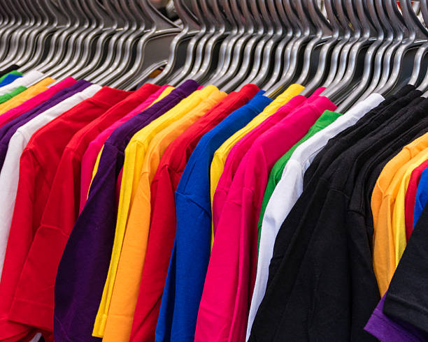 istock Various colored T-shirts on hangers 509914818