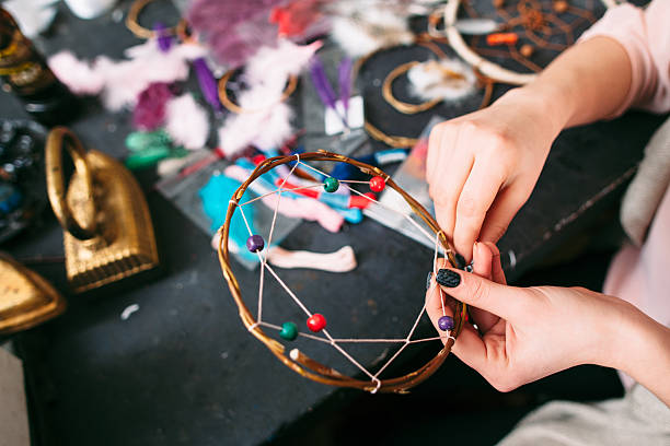 istock woman makes Dreamcatcher of sewing accessories. 509914916