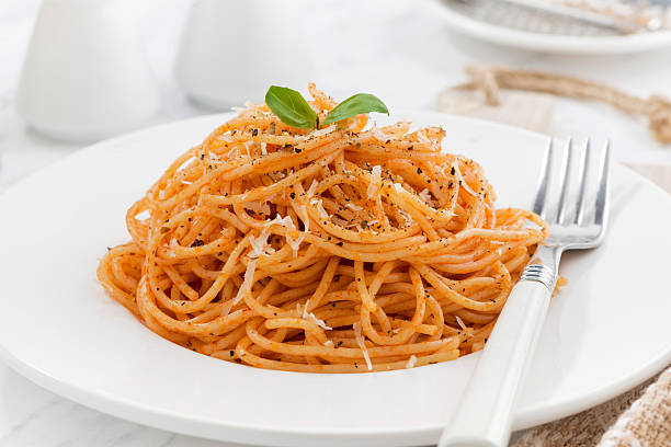 istock pasta with tomato sauce on a white plate, closeup 509915300