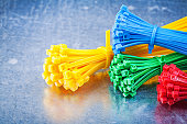 Multicolored plastic zip cable ties on metallic background const