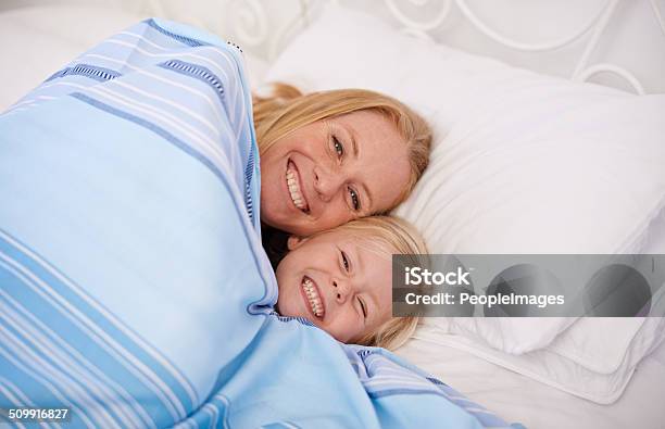 Snuggling Together Under The Covers Stock Photo - Download Image Now - 30-39 Years, 4-5 Years, Adult