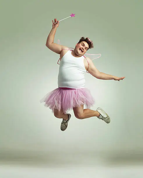 An overweight man comically dressed-up in a pink fairy costume