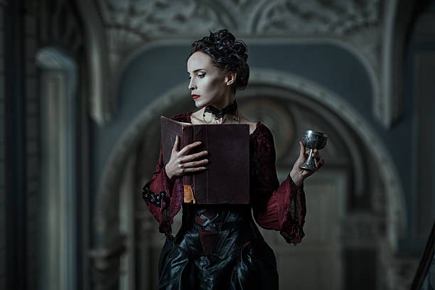 Mystic woman with a book. Mystic woman with book and cup in the Gothic style. vampire woman stock pictures, royalty-free photos & images