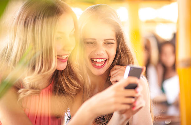 istock Teenage girls making fun with smartphone 509918921