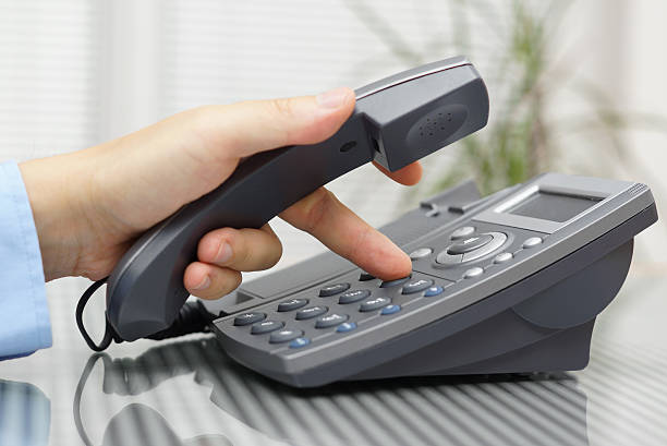 istock businessman hand is dialing  phone number with picked up headset 509919367