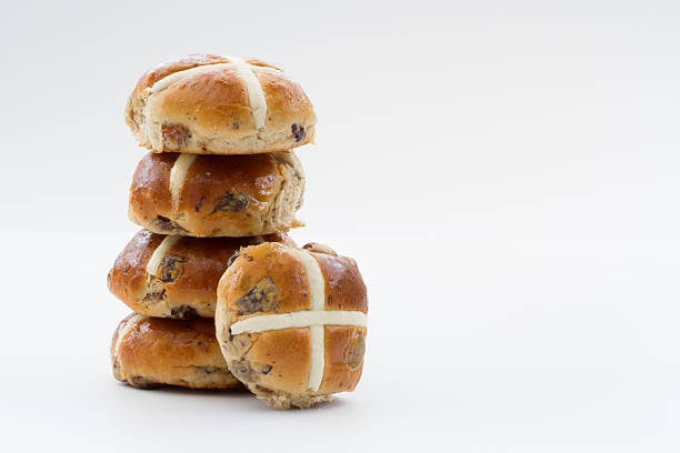Easter Hot Cross Buns A stack of Easter holiday hot cross buns on an isolated white background. hot x bun stack stock pictures, royalty-free photos & images